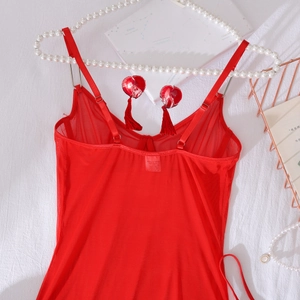 Detail of red sheer mesh lingerie with heart charms and tassels on a luxury white background