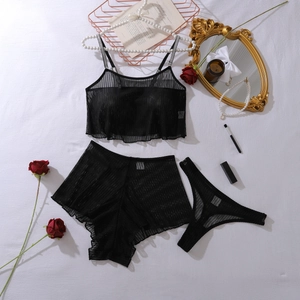 Flat lay of black mesh lingerie set with lace shorts and elegant lifestyle props