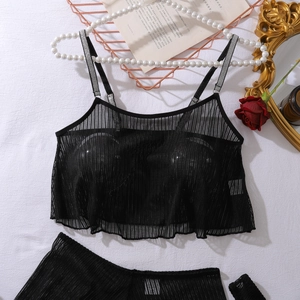 Detail view of black mesh lingerie set with ruffle trim and lace accents on white background