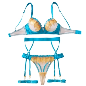 Three-piece turquoise lingerie set with floral embroidery, underwire bra, and garter belt