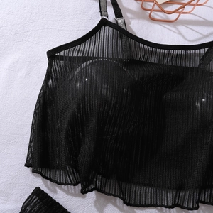 Close-up of black mesh sheer camisole with built-in pads and fine vertical stripes