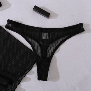 Detail shot of black sheer mesh lingerie set with S-size label and ribbed fabric texture