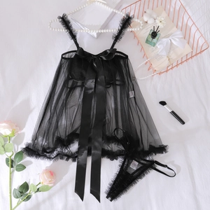Détail d'un ensemble de lingerie en mesh noir avec grand nœud en satin et bords à volants