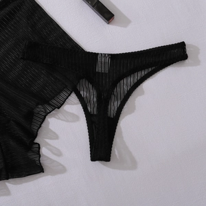 Detail view of black sheer mesh thong with vertical stripes and high-quality texture