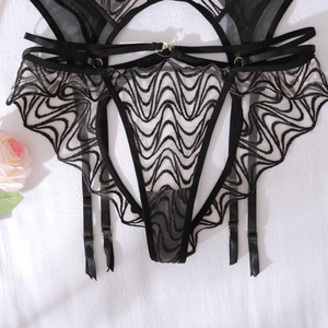 Detailed view of black lace garter belt and thong with golden metal adjusters