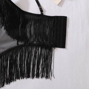Detail view of black tassel mesh lingerie with adjustable straps and golden metal buckles