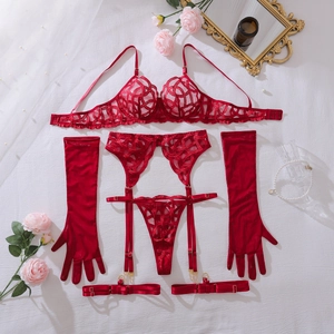 Flat lay of red floral embroidery lace lingerie set with silk gloves and rose petals