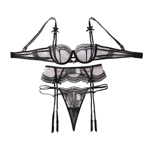 Three-piece black lace lingerie set with bow details and garter belt on white background