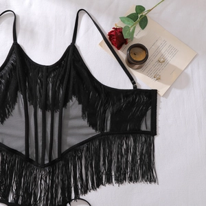 Detail view of a black mesh camisole with layered fringe and delicate straps