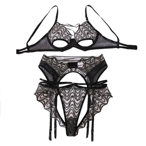 Three-piece black lace lingerie set with sheer embroidery and ruffled garter belt