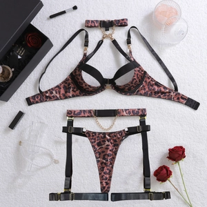 Flat lay of leopard print lingerie set with metal chains, garters and gold buckles
