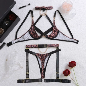 Detailed macro view of leopard print lingerie set with metal chains and gold buckles