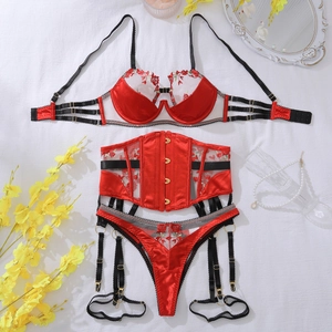 Flat lay of red floral embroidery lingerie set with garter belt and satin straps
