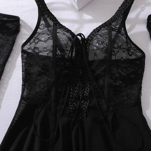 Detail of black sheer lace bodysuit featuring criss-cross lacing and matching arm sleeves