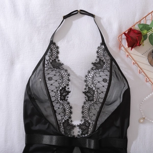 Detail of black lace bodysuit with halter neck, adjustable straps and satin bow accent