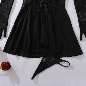Detail of black lace bodysuit with sheer panels, matching gloves and rose accessory