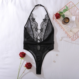 Close-up of black lace floral embroidery and sheer mesh on a halter neck bodysuit