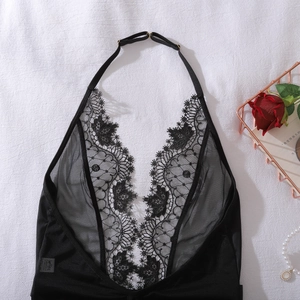 Flat lay of black floral lace teddy lingerie with sheer mesh and metal hardware details