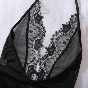 Detail of the intricate floral lace and sheer mesh on this sexy black one-piece bodysuit