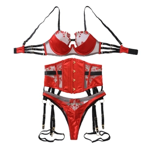 Three-piece red lingerie set with rose embroidery, lace bra, and matching garter belt