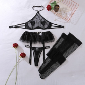 Detail of black mesh lingerie set with heart patches, garter belt and polka dot stockings