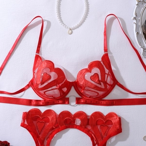 Detailed view of red heart lace lingerie set with underwire cups and strappy waist details