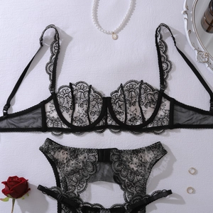 Detailed view of black floral embroidery lace lingerie set on elegant white background