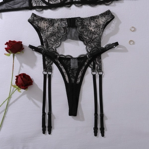 Close-up of black floral lace garter belt with adjustable straps and metal fasteners