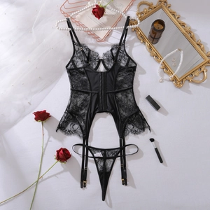 Flat lay of black floral lace lingerie set with garters, roses and vintage mirror