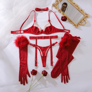 Flat lay of red lingerie set with bow choker and feather trimmed sheer long gloves