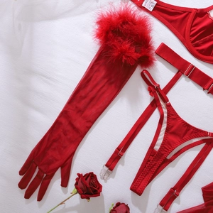 Detail of red lingerie set with feathered sheer gloves and floral romantic accents