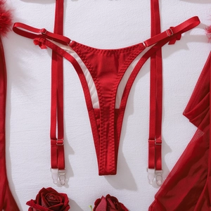 Detail of red satin lingerie set with bow lace-up thong and adjustable garter belt