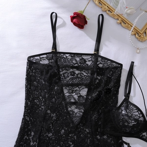 Flat lay of black floral lace lingerie set with red rose and vintage mirror details