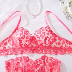 Detailed view of pink leopard lace lingerie set with mesh fabric and scalloped lace edges