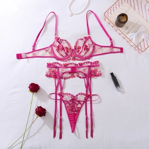 Detailed flat lay of a 3-piece sheer mesh lingerie set with red floral embroidery