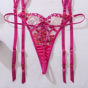 Detail of rose red floral embroidery on lace garter belt set with adjustable straps
