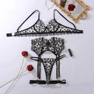 Detailed flat lay of a 3-piece leopard mesh lingerie set with lace trim and accessories