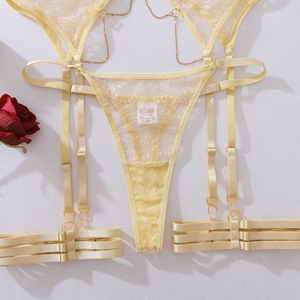 Detail of pale yellow lace lingerie set with metal chains and size S wash label