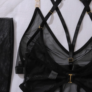Detailed view of black mesh lingerie set with gold metal rings and adjustable straps