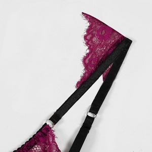 Detail of fuchsia eyelash lace and black elastic straps with silver metal rings