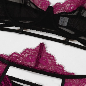 Detail view of purple eyelash lace and black mesh fabric texture with S size tag