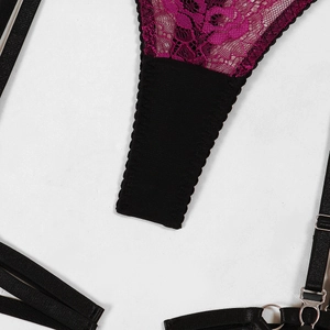 Close-up of fuchsia lace stitching and black mesh fabric with metal buckles on lingerie