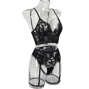 Detailed close-up of delicate black mesh embroidery on a V-neck lace lingerie set