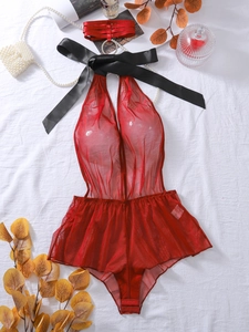 Detail of red mesh bodysuit with halter neck, satin bow, and silk leg garter accessories