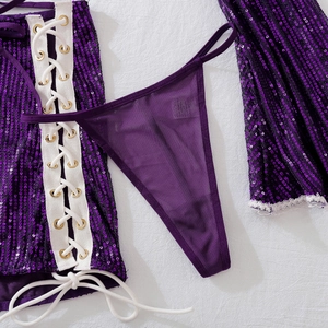 Detail of purple sequin skirt featuring lace-up side design and metallic eyelets