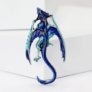 Elegant Western dragon brooch with blue enamel gradient on a minimalist white display