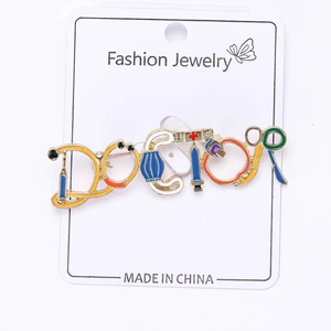 Detailed view of DOCTOR letter brooch with stethoscope and medical tool elements