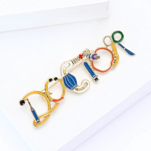Creative doctor enamel brooch with stethoscope and medical icons on a gold alloy base