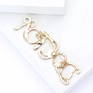 Detailed back view of the vintage gold metal brooch featuring a safety pin clasp