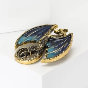 Detailed close-up of a high-end enamel dragon brooch with intricate wing textures